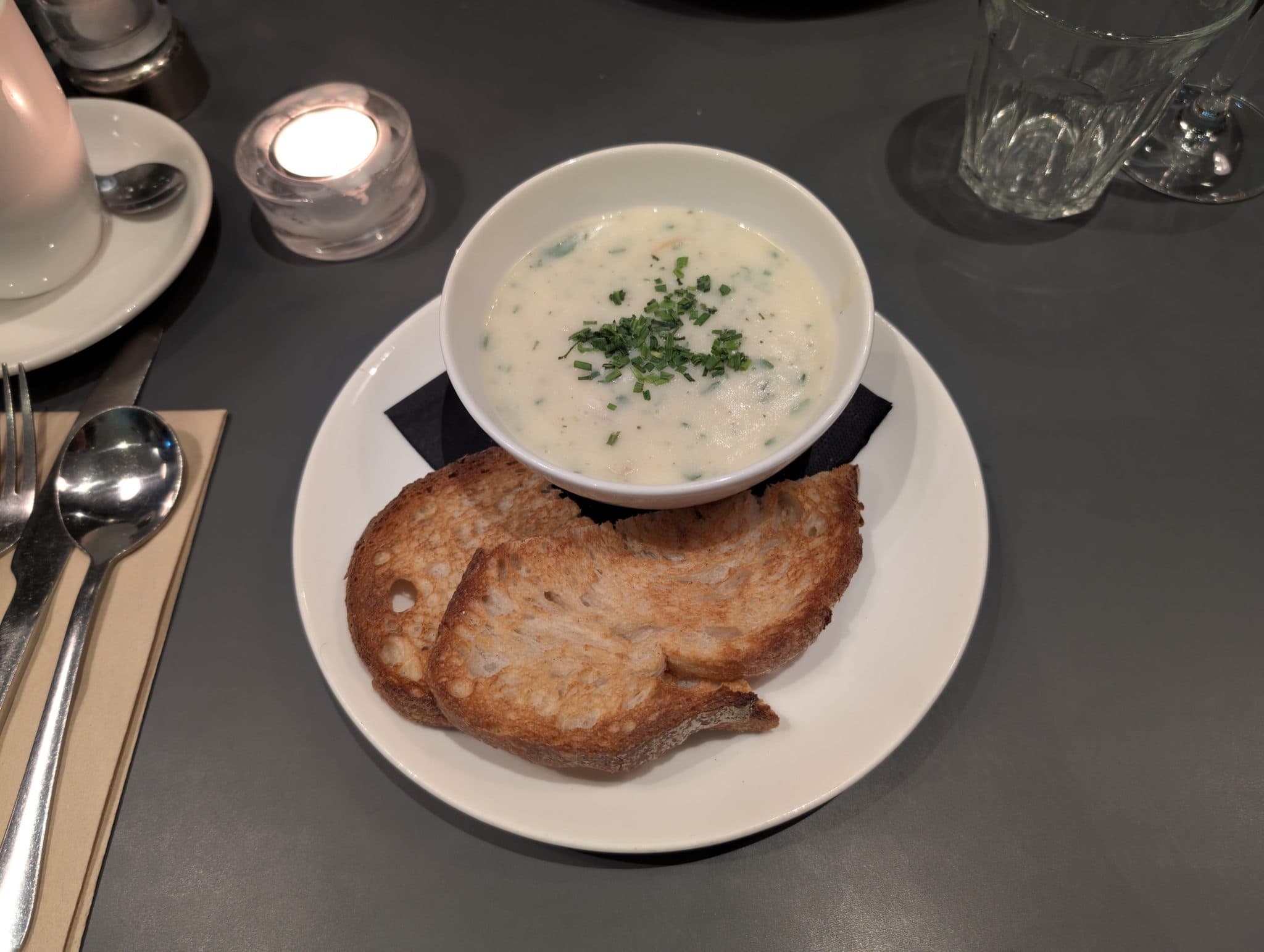 Bowl of creamy fish soup with brown bread
